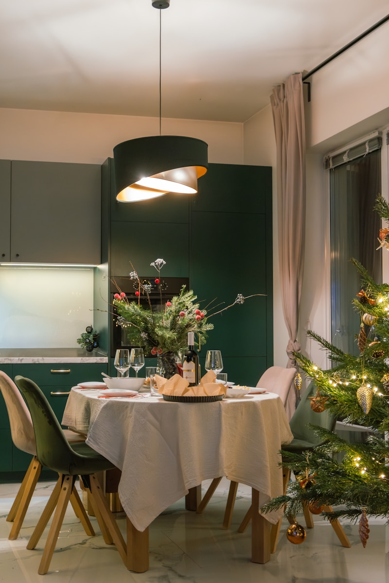 A dining room with a christmas tree in the corner